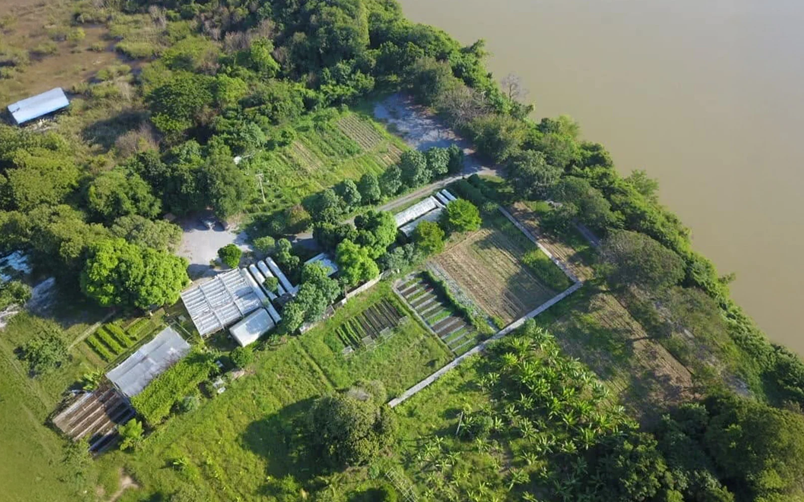 The farm and its setting beside the river.